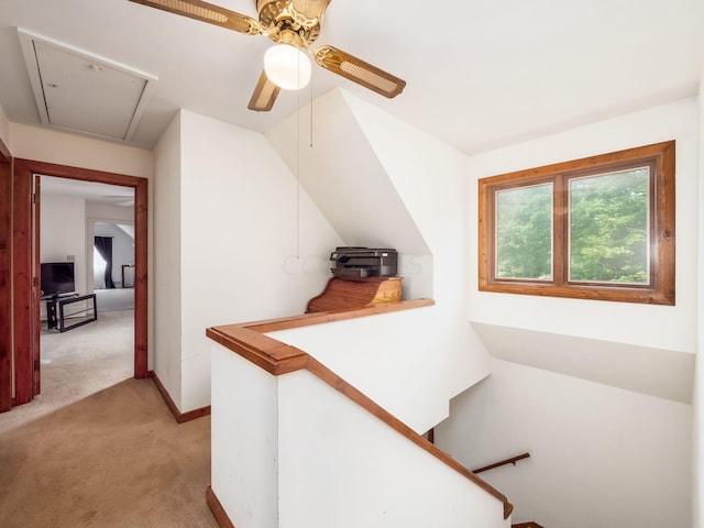 hallway featuring light colored carpet and vaulted ceiling