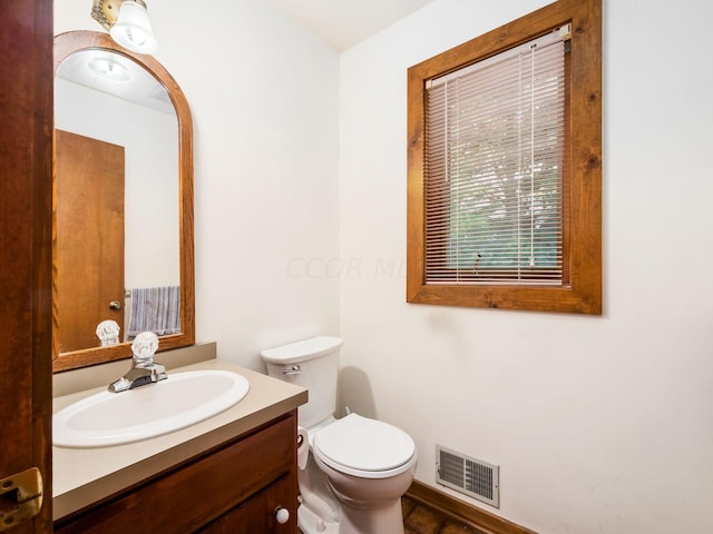 bathroom featuring vanity and toilet