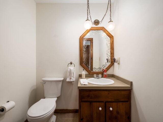 bathroom featuring tile patterned floors, vanity, and toilet