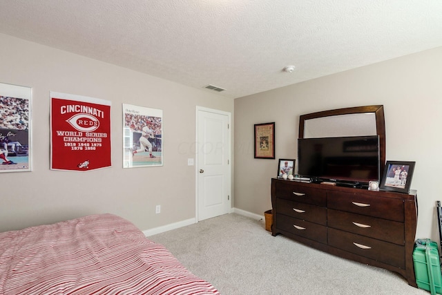 carpeted bedroom featuring a textured ceiling