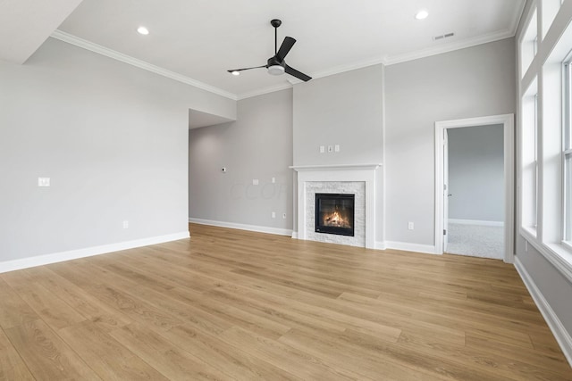 unfurnished living room featuring ceiling fan, crown molding, and light hardwood / wood-style floors