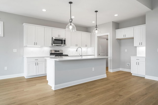 kitchen featuring white cabinetry, appliances with stainless steel finishes, and light hardwood / wood-style flooring