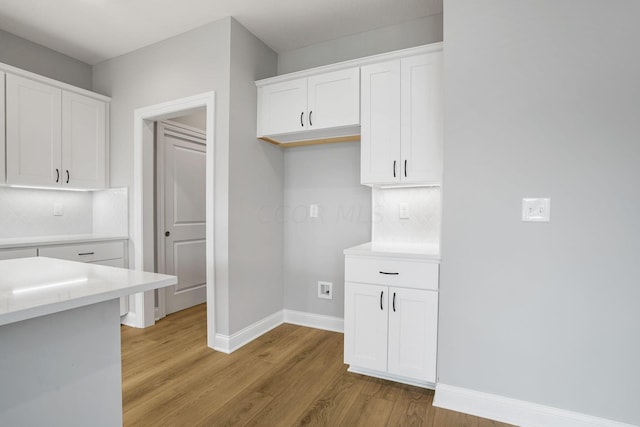 kitchen featuring white cabinetry and light hardwood / wood-style flooring