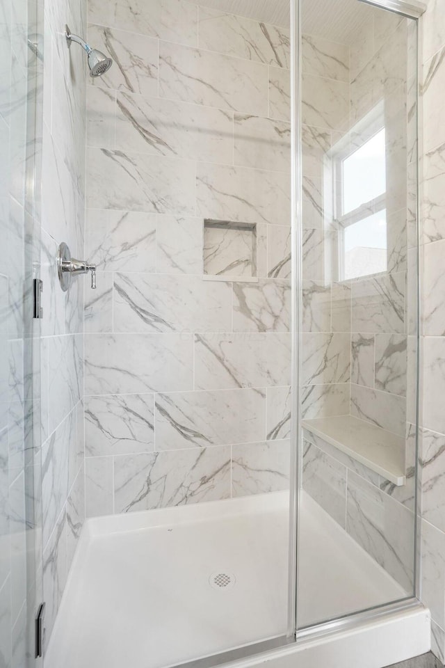 bathroom with a shower with shower door