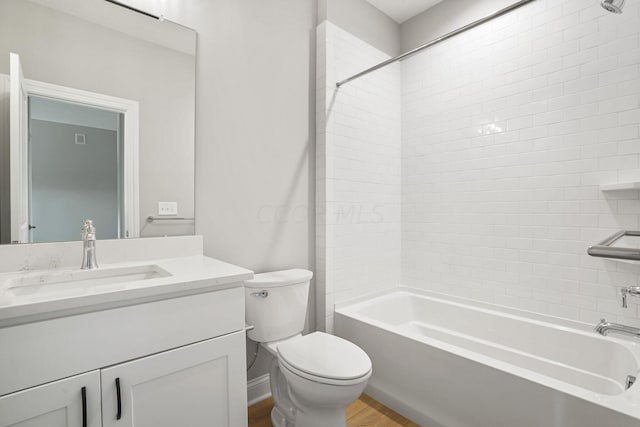 full bathroom with wood-type flooring, vanity, toilet, and tiled shower / bath