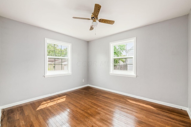 spare room featuring wood-type flooring and ceiling fan