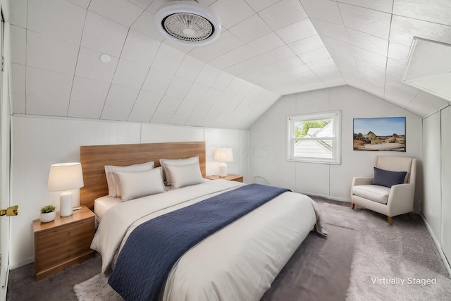 bedroom featuring dark carpet and lofted ceiling