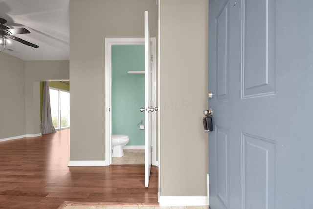 bathroom featuring hardwood / wood-style flooring, ceiling fan, and toilet