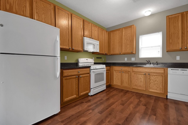 kitchen with a textured ceiling, sink, dark hardwood / wood-style floors, and white appliances