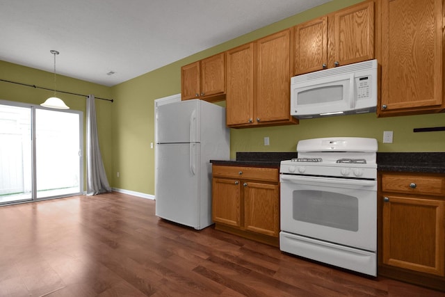 kitchen with decorative light fixtures, white appliances, and dark wood-type flooring