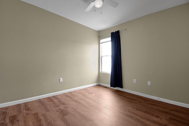 spare room featuring hardwood / wood-style flooring, ceiling fan, and lofted ceiling