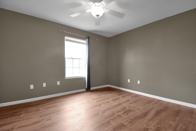 spare room featuring ceiling fan and light hardwood / wood-style flooring