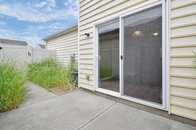 entrance to property featuring a patio and central AC unit