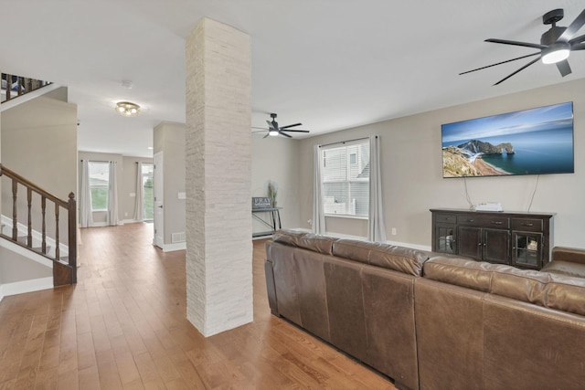 667 Green Forest Pl, Lithopolis, OH 43136 - living area with a ceiling fan, stairway, wood finished floors, and plenty of natural light