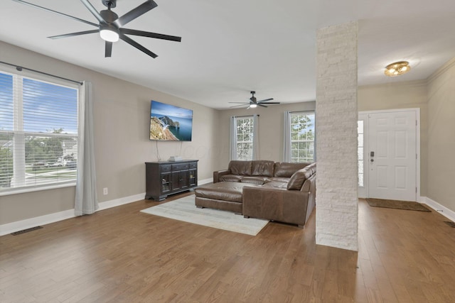 667 Green Forest Pl, Lithopolis, OH 43136 - living room with ornate columns, a ceiling fan, wood finished floors, and baseboards