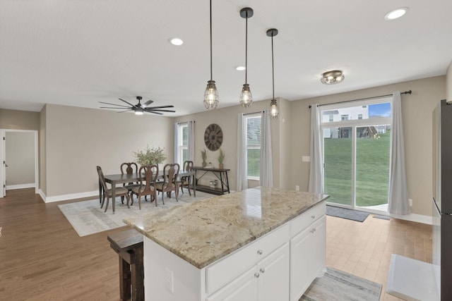 667 Green Forest Pl, Lithopolis, OH 43136 - kitchen with light wood-style flooring, white cabinetry, baseboards, recessed lighting, and a kitchen island