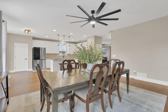 667 Green Forest Pl, Lithopolis, OH 43136 - dining room featuring light wood-style flooring, a ceiling fan, baseboards, and recessed lighting