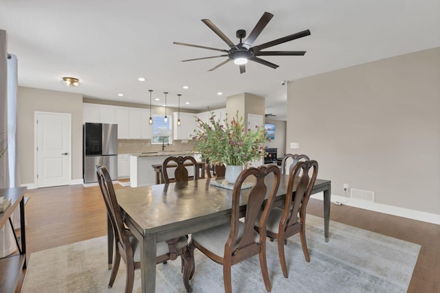 667 Green Forest Pl, Lithopolis, OH 43136 - dining area featuring light wood-type flooring, a ceiling fan, baseboards, and recessed lighting