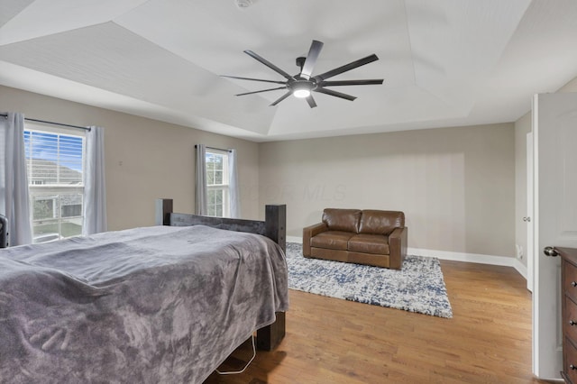 667 Green Forest Pl, Lithopolis, OH 43136 - bedroom with a raised ceiling, wood finished floors, baseboards, and ceiling fan