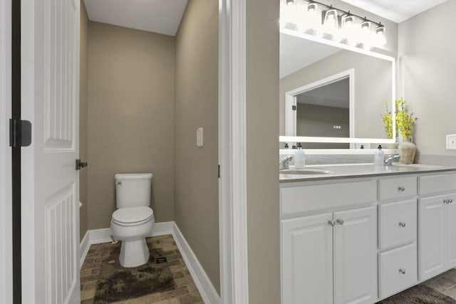 667 Green Forest Pl, Lithopolis, OH 43136 - full bathroom with double vanity, toilet, baseboards, and stone finish flooring