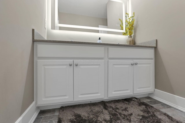 667 Green Forest Pl, Lithopolis, OH 43136 - bathroom featuring baseboards, vanity, and stone finish flooring