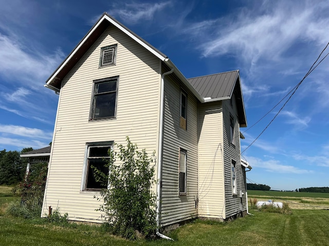 view of side of home featuring a yard