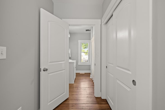 corridor with dark wood-type flooring