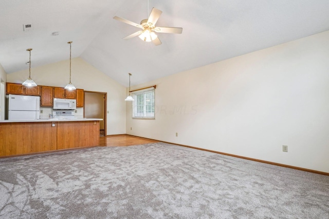 kitchen featuring lofted ceiling, white appliances, ceiling fan, light colored carpet, and kitchen peninsula