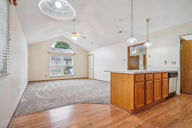 kitchen featuring pendant lighting, vaulted ceiling, light hardwood / wood-style flooring, and ceiling fan