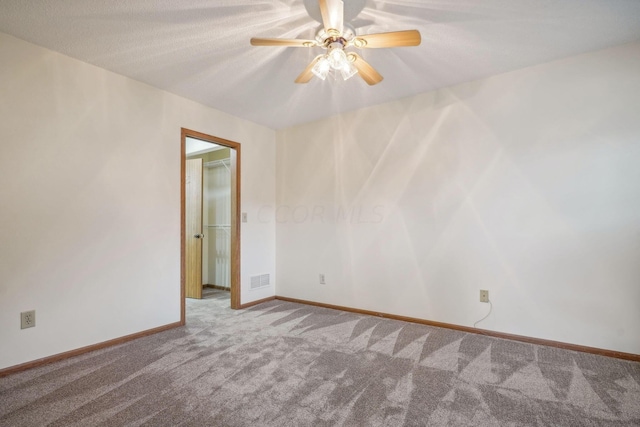 unfurnished room featuring carpet flooring, ceiling fan, and a textured ceiling