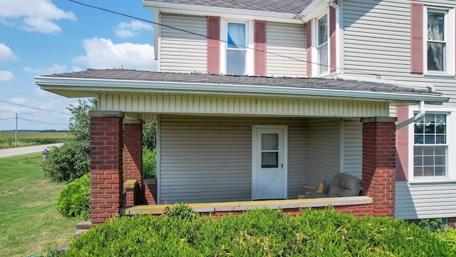 view of exterior entry featuring a porch