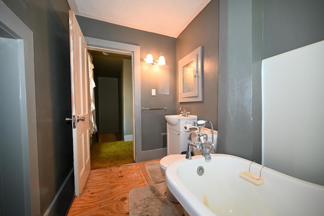 bathroom with a washtub and vanity