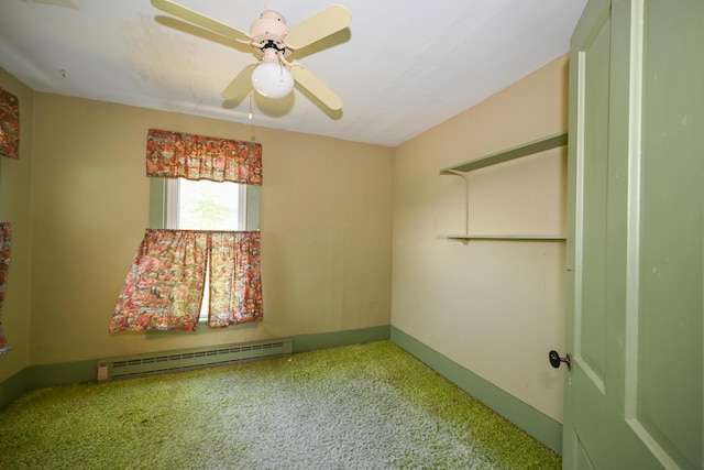 carpeted empty room with ceiling fan and baseboard heating