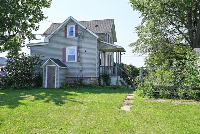 rear view of house with a lawn