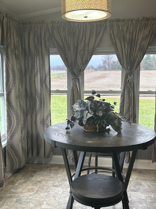 dining space featuring crown molding