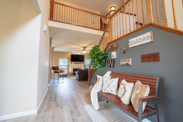 living room featuring light wood-type flooring and ceiling fan