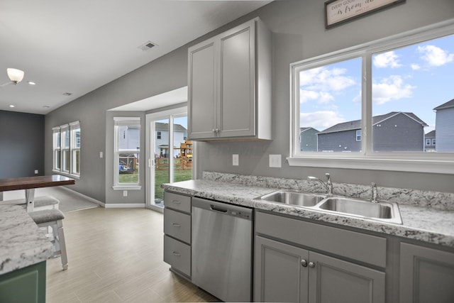 kitchen featuring dishwasher, gray cabinets, and sink