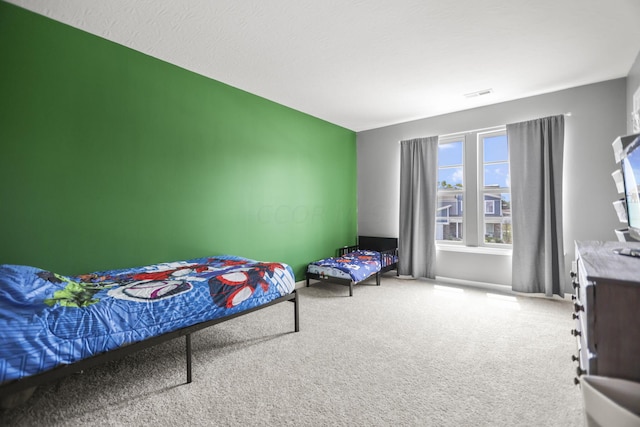 bedroom featuring carpet floors and a textured ceiling