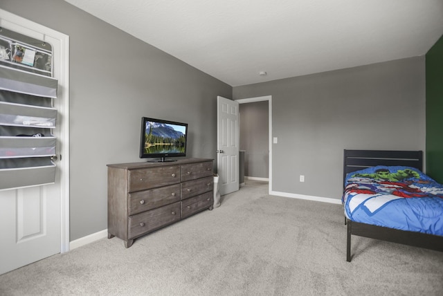 bedroom featuring light carpet