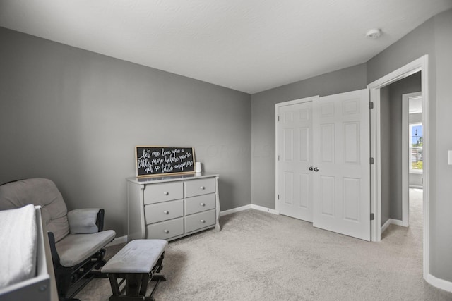 living area featuring light carpet