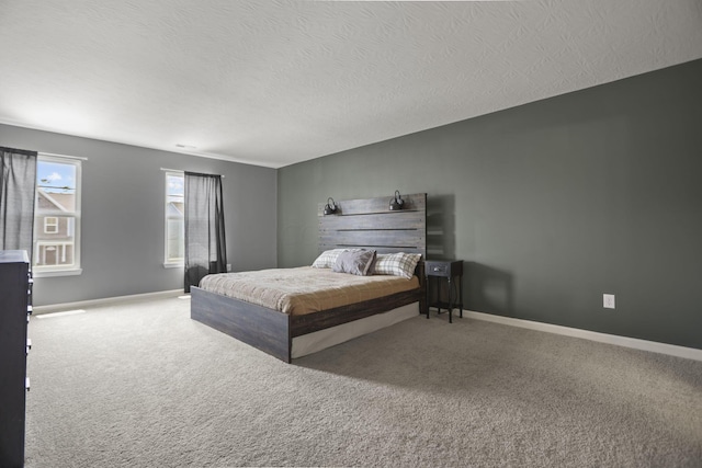 bedroom featuring a textured ceiling and carpet floors