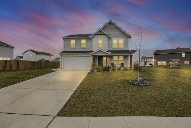 view of front of property with covered porch, a yard, and a garage