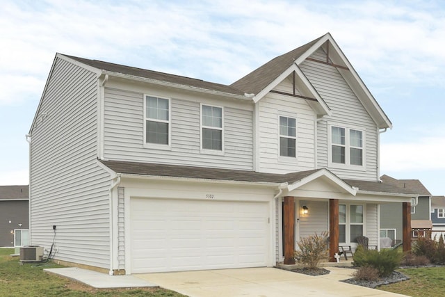 view of front of home with a garage and central AC