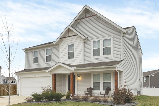 view of front facade with a front yard, a garage, and covered porch