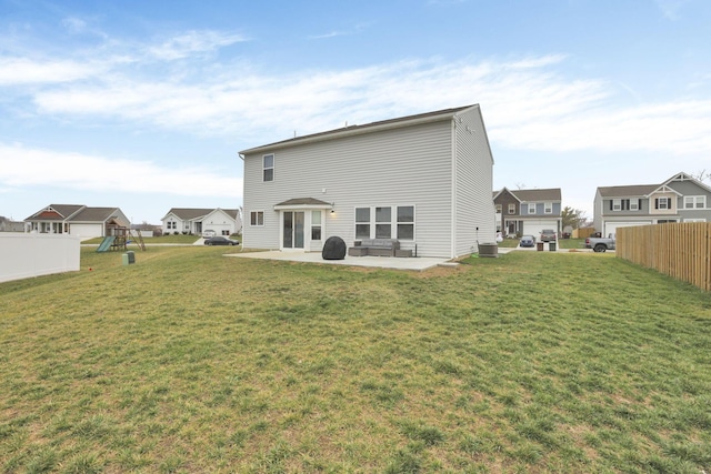 back of property with a patio, a playground, and a lawn