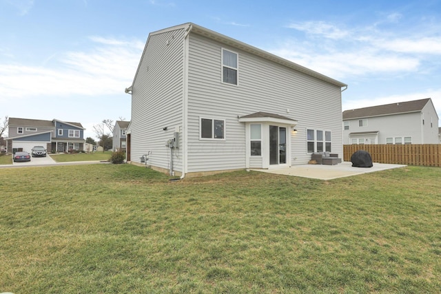 rear view of property with a yard and a patio