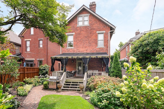 back of property with a wooden deck