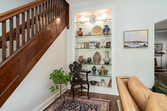 stairs featuring hardwood / wood-style floors and built in features