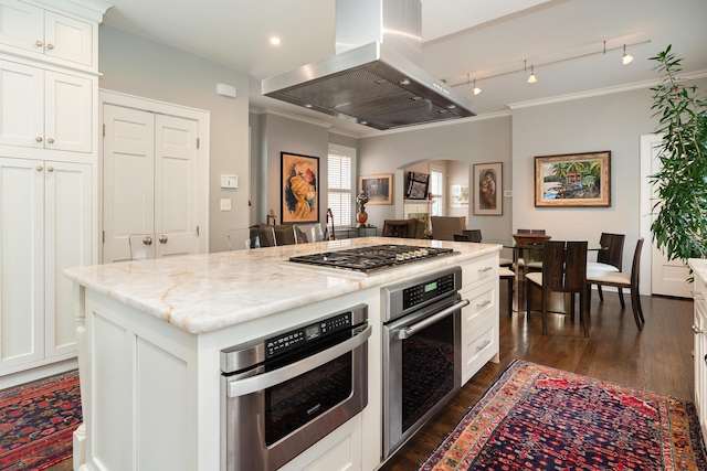 kitchen featuring island range hood, a kitchen island, stainless steel appliances, light stone countertops, and white cabinets