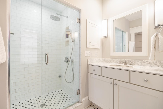 bathroom featuring an enclosed shower and vanity